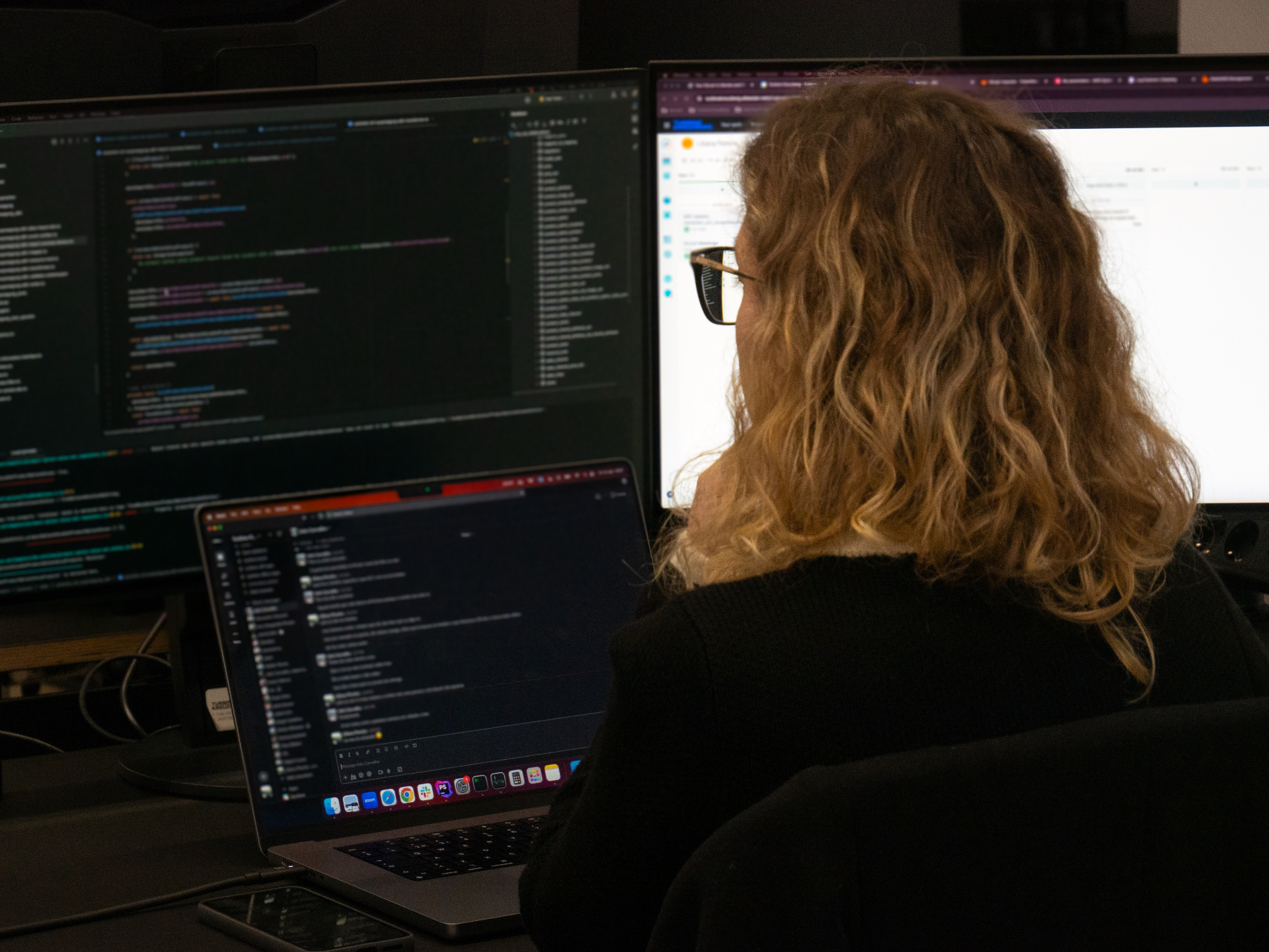 Liliana Pereira working at her desk with multiple screens